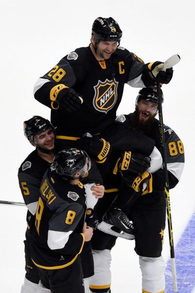 John Scott is carried off the ice after leading his team to victory at the NHL All-Star Game.